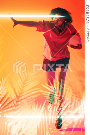 Illuminated line and plants over biracial female player with rugby ball running on orange background Illuminated line and plants over biracial female player with rugby ball running on orange background 97559952