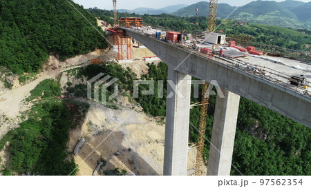 Aerial drone view on highway bridge road under construction. Construction of the viaduct on the modern new road. Aerial drone view on highway bridge road under construction. Construction of the viaduct on the modern new road. 97562354