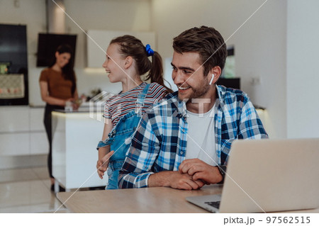 Father and daughter in modern house talking together on laptop with their family during holidays. The life of a modern family Father and daughter in modern house talking together on laptop with their family during holidays. The life of a modern family 97562515