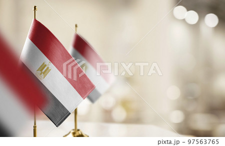 Small flags of the Egypt on an abstract blurry background 97563765