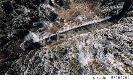 Aerial high angle view of narrow winding curvy mountain road. 97564266