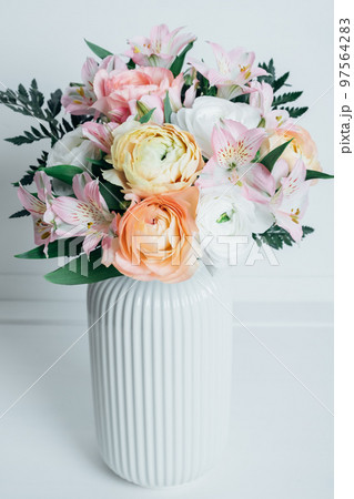 Beautiful colorful flowers in bloom in white vase. Beautiful colorful flowers in bloom in white vase. 97564283