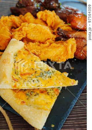 cheese pizza, caramelized chicken with sesame and garlic, meat strips in breadin cheese pizza, caramelized chicken with sesame and garlic, meat strips in breadin 97564309