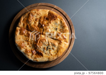 top view of traditional georgian bread khachapuri with filling on wooden board 97564800