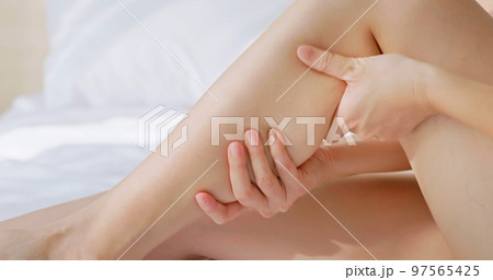 woman touch leg woman touch leg 97565425
