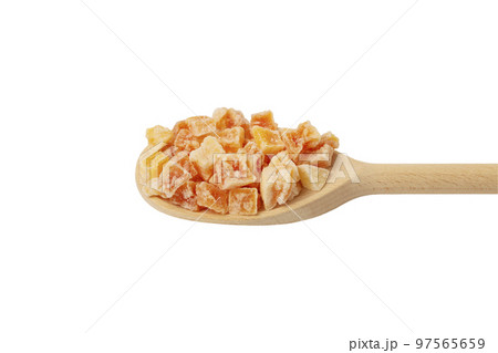 diced candied papaya on wooden spoon isolated on white background. nutrition. food ingredient. 97565659