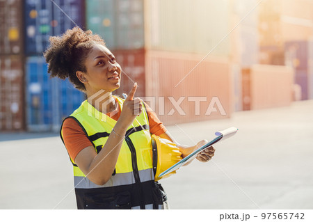 African woman cargo logistics industry staff worker happy working in port shipyard check containers African woman cargo logistics industry staff worker happy working in port shipyard check containers 97565742
