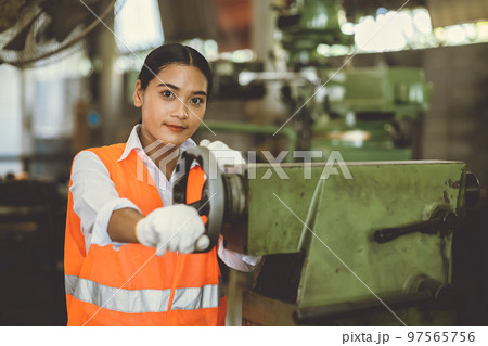 teen girl working in heavy industry with dirty lathe machine tool industry factory happy smile teen girl working in heavy industry with dirty lathe machine tool industry factory happy smile 97565756