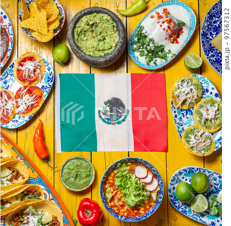 Mexican festive food for independence day independencia - around mexican flag. Top view , Yellow background. Mexican festive food for independence day independencia - around mexican flag. Top view , Yellow background. 97567312