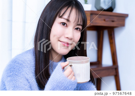 コーヒーを飲むニットの女性 97567648