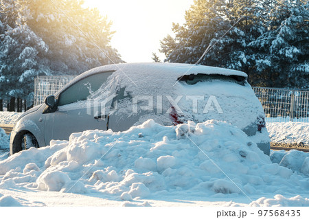 The car parked on the street after heavy snowfall The car parked on the street after heavy snowfall 97568435