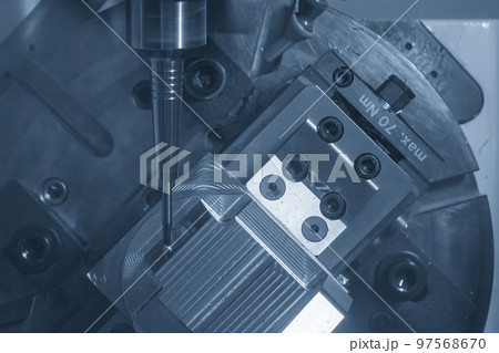 The 5-axis CNC milling machine  cutting the metal mold part. 97568670