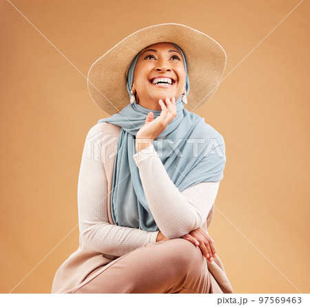 Hijab, fashion and happy woman thinking on studio background, trendy hat and summer style. Laughing, happiness and mature muslim model, islamic culture and beauty for positive mindset, ideas or smile 97569463
