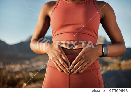 Woman, nature fitness or hands on stomach in diet wellness, body healthcare or abs muscle growth in workout training or sunrise exercise. Zoom, sports athlete or person, belly digestion or strong gut Woman, nature fitness or hands on stomach in diet wellness, body healthcare or abs muscle growth in workout training or sunrise exercise. Zoom, sports athlete or person, belly digestion or strong gut 97569648