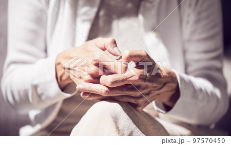 Anxiety, grief and hands of a senior woman in a therapy session for loss, mental health and support. Hope, counseling and elderly lady pensioner in retirement getting help at psychology rehab center. Anxiety, grief and hands of a senior woman in a therapy session for loss, mental health and support. Hope, counseling and elderly lady pensioner in retirement getting help at psychology rehab center. 97570450