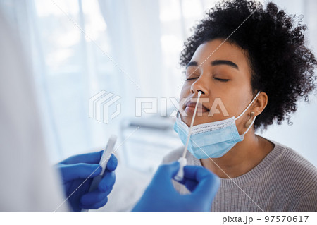 Covid, health and medical test with black woman, nasal swab and doctor with patient, healthcare and face mask. Sample collection for PCR, diagnosis and health care, covid 19 compliance and safety. Covid, health and medical test with black woman, nasal swab and doctor with patient, healthcare and face mask. Sample collection for PCR, diagnosis and health care, covid 19 compliance and safety. 97570617