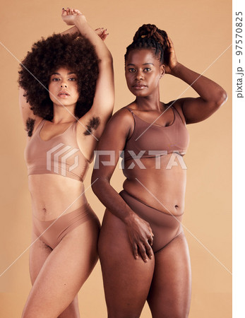 Body positive, empowerment and black women with body hair for natural beauty, care for skin and confidence on brown studio background. Self love, wellness and African model friends with hairy armpit Body positive, empowerment and black women with body hair for natural beauty, care for skin and confidence on brown studio background. Self love, wellness and African model friends with hairy armpit 97570825