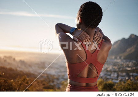 Black woman, stretching and fitness on mountain for relax training, cardio workout or runner freedom outdoor. African woman, athlete warm up and stretch arms, back and focus in nature for sunset 97571304