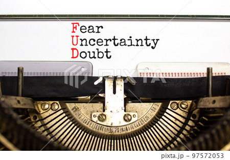 FUD fear uncertainty doubt symbol. Concept words FUD fear uncertainty doubt typed on old retro typewriter. Beautiful white background. Business and FUD fear uncertainty doubt concept. Copy space. 97572053