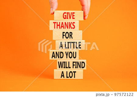 Give thanks symbol. Concept words Give thanks for a little and you will find a lot on wooden blocks. Beautiful orange background copy space. Businessman hand. Business motivational give thanks concept Give thanks symbol. Concept words Give thanks for a little and you will find a lot on wooden blocks. Beautiful orange background copy space. Businessman hand. Business motivational give thanks concept 97572122