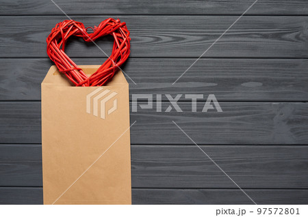 Blank envelope on wooden plank table with heart shape Blank envelope on wooden plank table with heart shape 97572801