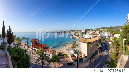 Sandy Beach, Colorful Blue Sea Water and Residential Homes on Coast. Palma, Balearic Islands, Spain Sandy Beach, Colorful Blue Sea Water and Residential Homes on Coast. Palma, Balearic Islands, Spain 97573012