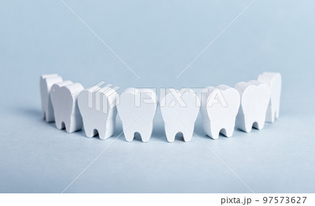 Toy teeth row on blue background 97573627