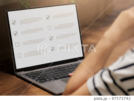 Woman Take an assessment, Questionnaire online with checkboxes, Evaluation, Online survey online exam Choosing the right answer in the exam, Test questions. Filling out an online survey form business. Woman Take an assessment, Questionnaire online with checkboxes, Evaluation, Online survey online exam Choosing the right answer in the exam, Test questions. Filling out an online survey form business. 97573742