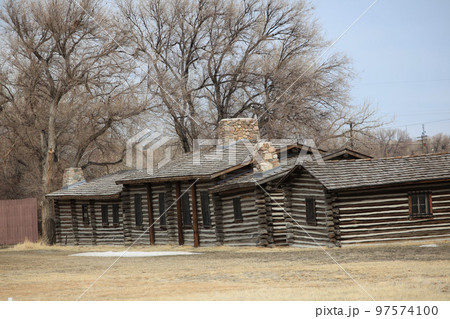 Log cabins displayed outdoors. 97574100