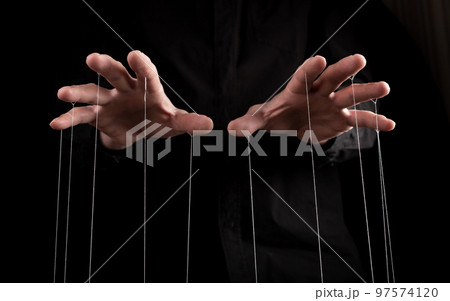 Man hands with strings on fingers. Manipulation, negative influence or addiction concept. Becoming dependent on alcohol, drugs, gambling. 97574120