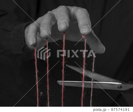 Overcoming addiction, getting rid of abuse and influence concept. Scissors cutting strings on man fingers. Mental health concerns or control and manipulation stop. Overcoming addiction, getting rid of abuse and influence concept. Scissors cutting strings on man fingers. Mental health concerns or control and manipulation stop. 97574191
