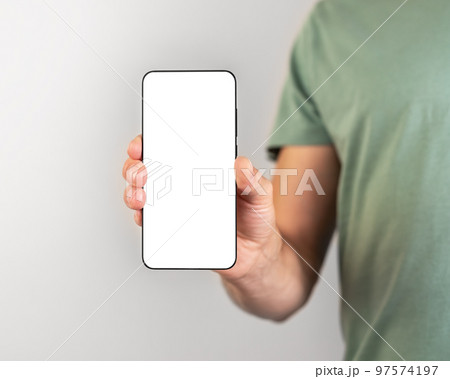 Man holding phone mockup in vertical position. Person using smartphone for showing photo or information. empty screen Man holding phone mockup in vertical position. Person using smartphone for showing photo or information. empty screen 97574197