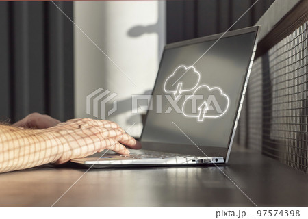 Cloud computing. Man using laptop for upload, storage, download or sharing files and data online. Male hands on computer keyboard closeup Cloud computing. Man using laptop for upload, storage, download or sharing files and data online. Male hands on computer keyboard closeup 97574398