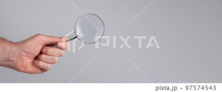 Banner with man hand with magnifying glass. Data search analysis, conducting research, nuances, important details study, preparation for exams concept. Space for text Banner with man hand with magnifying glass. Data search analysis, conducting research, nuances, important details study, preparation for exams concept. Space for text 97574543