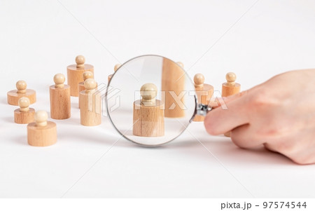 Social survey concept. Hand with magnifying glass and Montessori knobbed cylinders. Research conducting, gathering information about people lives, opinion, preferences. Social survey concept. Hand with magnifying glass and Montessori knobbed cylinders. Research conducting, gathering information about people lives, opinion, preferences. 97574544