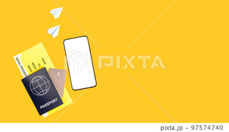 Banner with phone mockup, passport, boarding pass, credit card on orange background. Paper origami planes. Air travel concept. Essential items for going abroad. Copy space 97574740