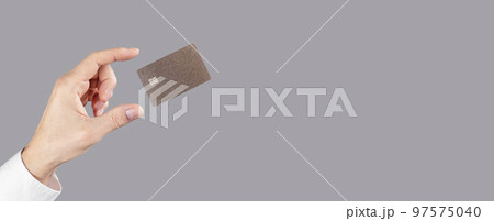 Hand and levitating credit card mockup on gray banner, background Hand and levitating credit card mockup on gray banner, background 97575040