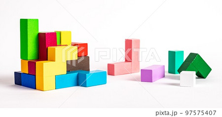 Colorful wooden elements of puzzle. Construction, formation concept. Kids logical game for problem solving skills development. Colorful wooden elements of puzzle. Construction, formation concept. Kids logical game for problem solving skills development. 97575407
