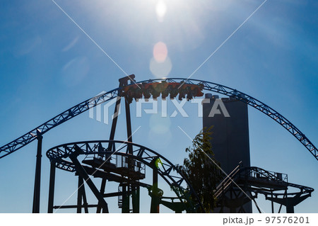 Ride roller coaster in blurred motion on sky background in amusement park Ride roller coaster in blurred motion on sky background in amusement park 97576201