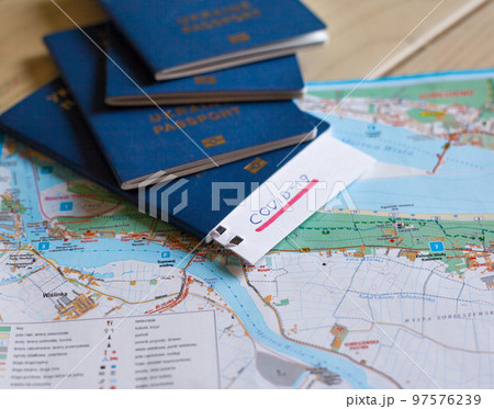 Passport and note with Covid-19 inscription. 97576239