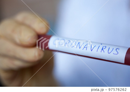 Hand holding blood test result for Coronavirus 97576262