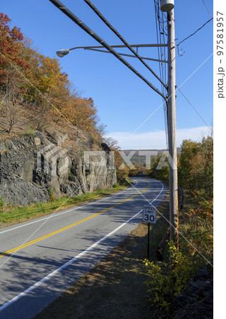 mountain road on a sunny day, blue sky in a background mountain road on a sunny day, blue sky in a background 97581957