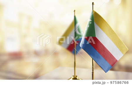 Small flags of the Comoros on an abstract blurry background 97586766