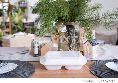 Food delivery service containers on table in white kitchen, festively served for celebration of Christmas and new year. Saving time, hot order, disposable plastic box, craft package. mock up Food delivery service containers on table in white kitchen, festively served for celebration of Christmas and new year. Saving time, hot order, disposable plastic box, craft package. mock up 97587397