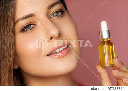 Beauty, makeup and skincare cosmetics model face portrait, woman holding skin care cosmetic essential oil bottle with dropper, luxury facial care product mockup 97588311