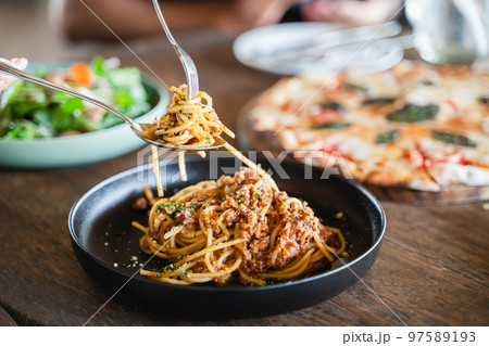 Eating food. people eating Italian food Pasta, Pizza, Salad on the table. Eating food. people eating Italian food Pasta, Pizza, Salad on the table. 97589193