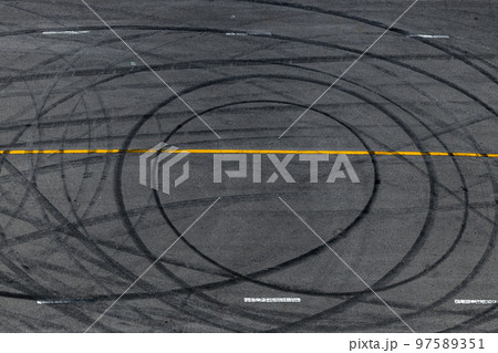 Tire track mark on asphalt tarmac road race track texture and background, Abstract background black tire tracks skid on asphalt road in racing circuit, Tire mark skid mark on asphalt road. 97589351