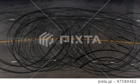 Top view tire tracks texture and background, Asphalt texture with line and tire marks, Automobile automotive tire skid mark on race track, Abstract texture car drift tire skid mark. 97589362
