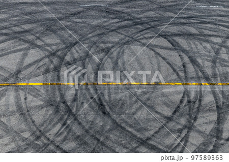 Top view tire tracks texture and background, Asphalt texture with line and tire marks, Automobile automotive tire skid mark on race track, Abstract texture car drift tire skid mark. Top view tire tracks texture and background, Asphalt texture with line and tire marks, Automobile automotive tire skid mark on race track, Abstract texture car drift tire skid mark. 97589363