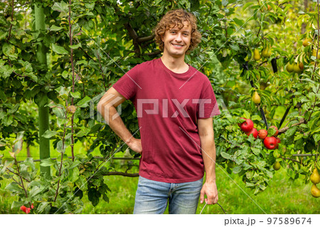 Cheerful Caucasian gardener working in the garden Cheerful Caucasian gardener working in the garden 97589674